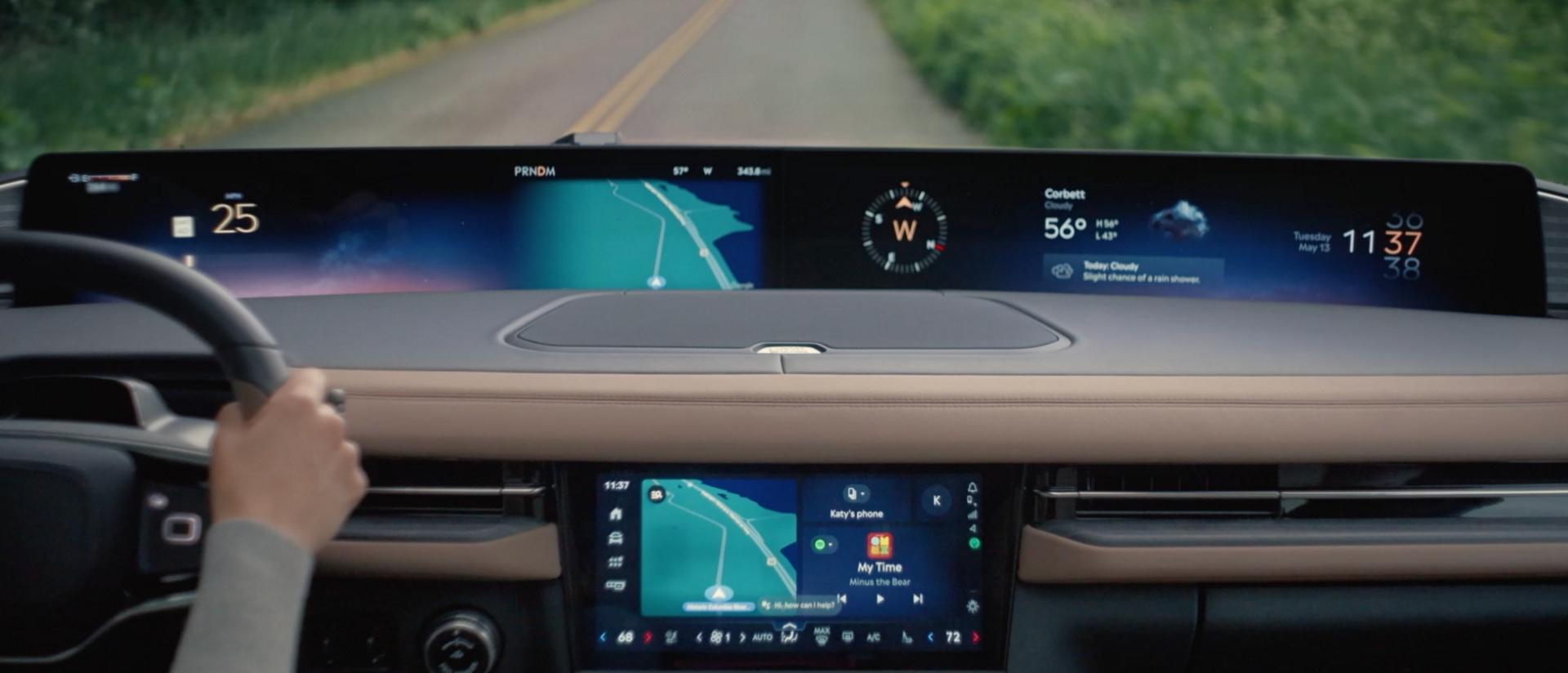 An interior driving shot of the 2027 Lincoln Navigator® showing the driver using voice-activated Google Assistant