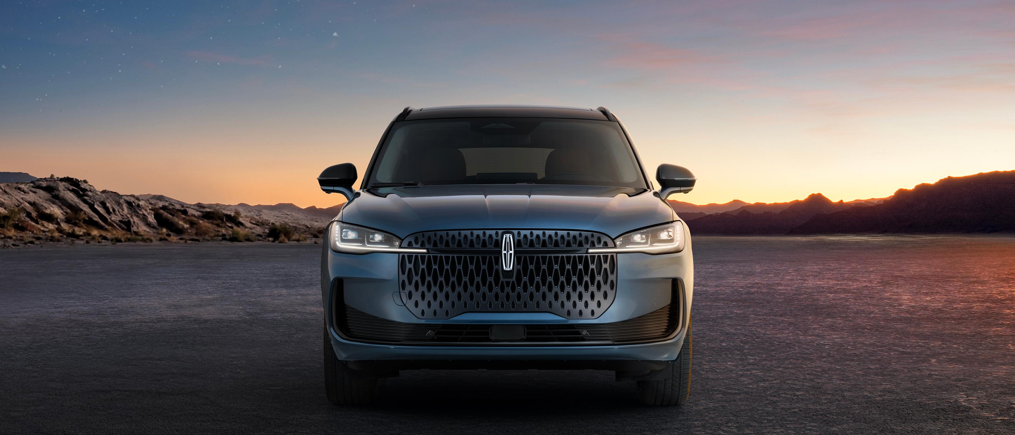 An illuminated Lincoln star emblem and light bar define the distinctive grille of the 2027 Lincoln Corsair® Hybrid 