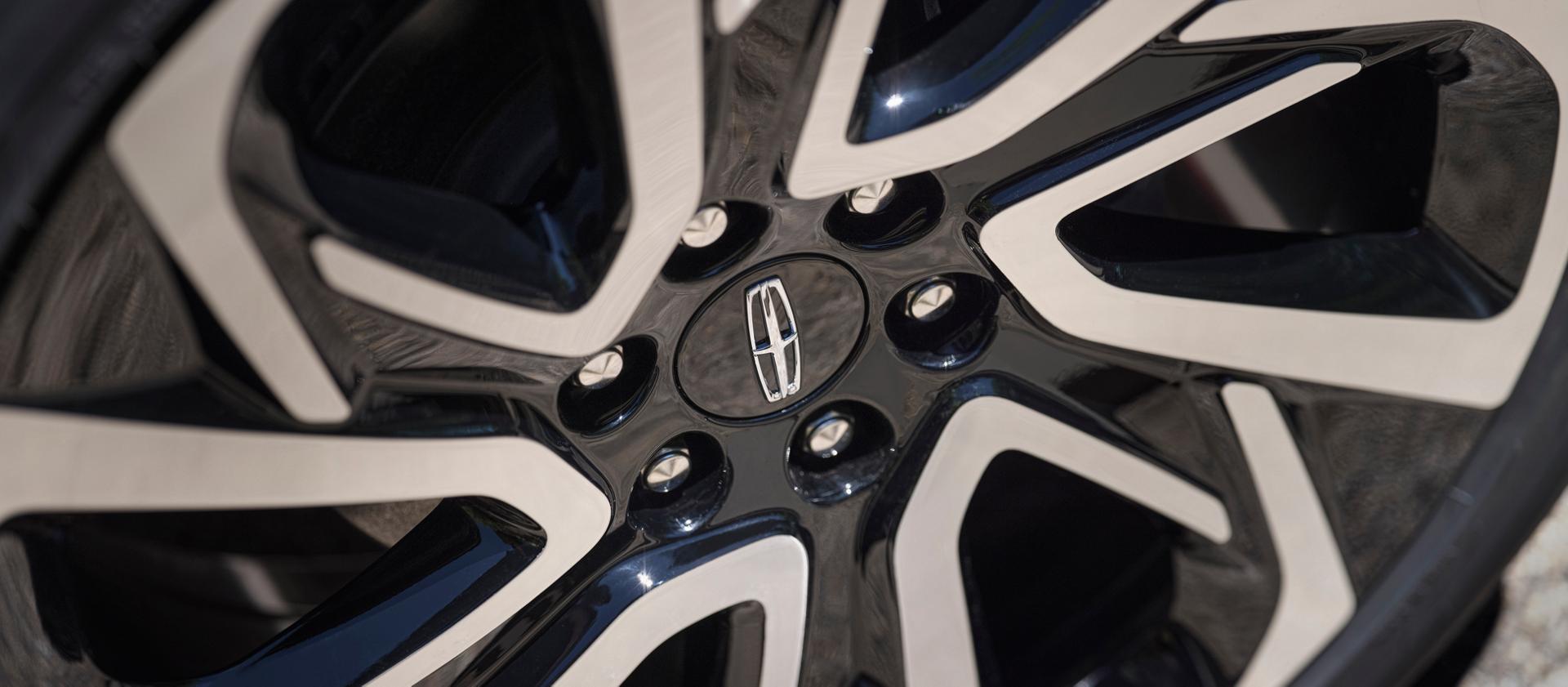 The available 24-inch High Gloss Ebony Black Wheel with Bright Machined Finish on a 2026 Lincoln Black Label Navigator® SUV