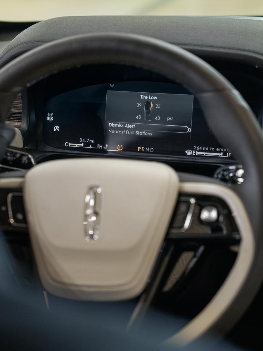Close-up of a Lincoln steering wheel and dashboard.
