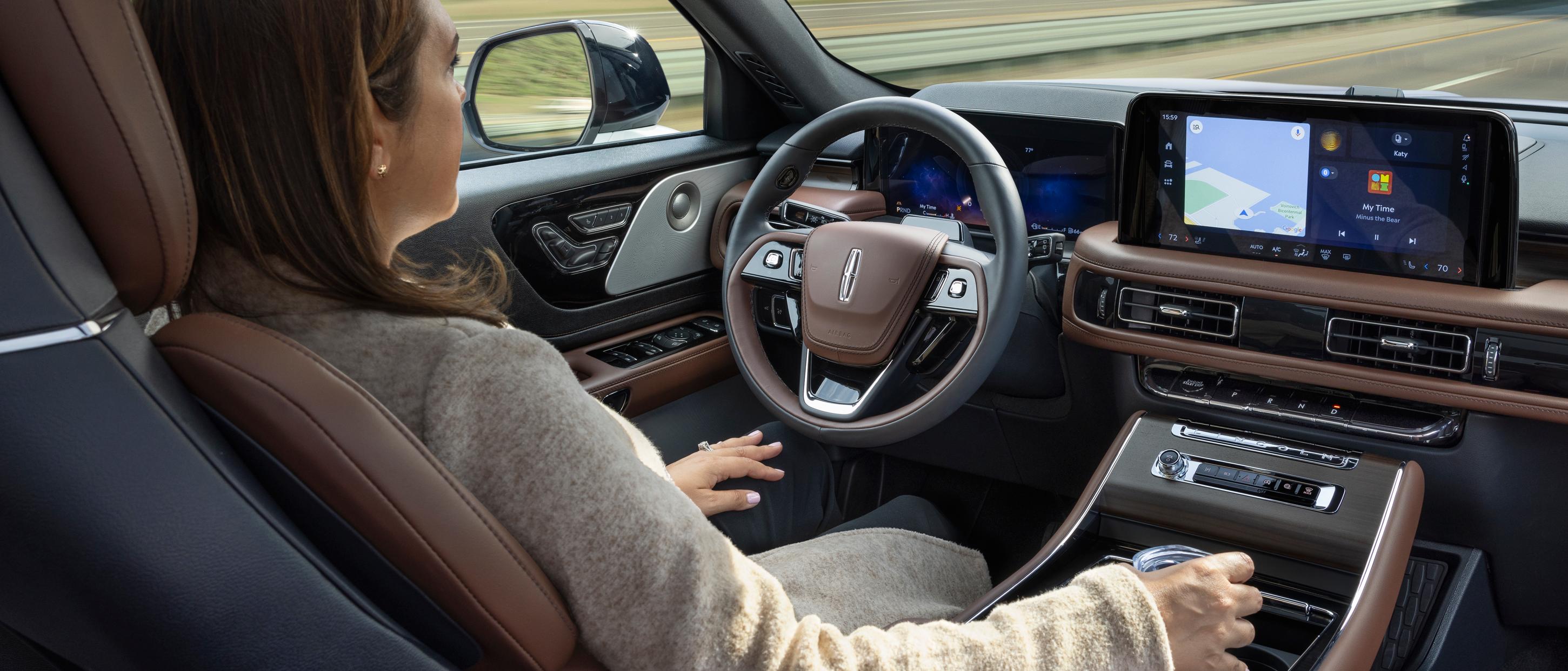 A woman operates the 2026 Lincoln Aviator® SUV hands-free with her eyes on the road using Lincoln BlueCruise