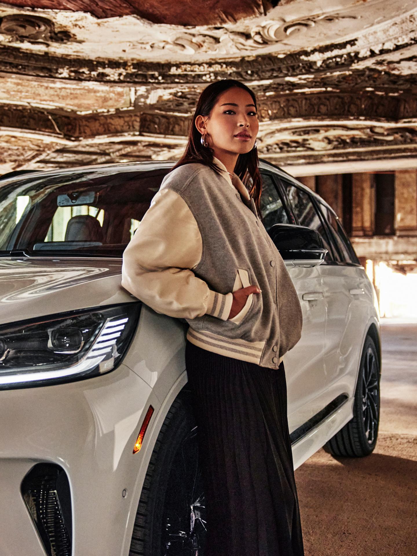 A woman leaning on a white 2025 Lincoln Aviator