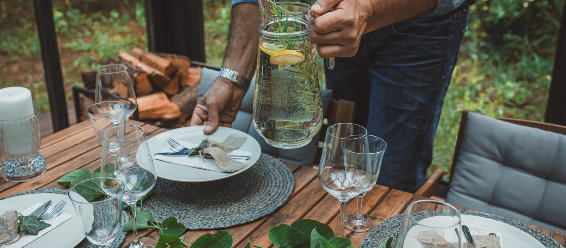 A person sets a dining table to reflect the spirit of the 2026 Lincoln Black Label™ Invitation theme