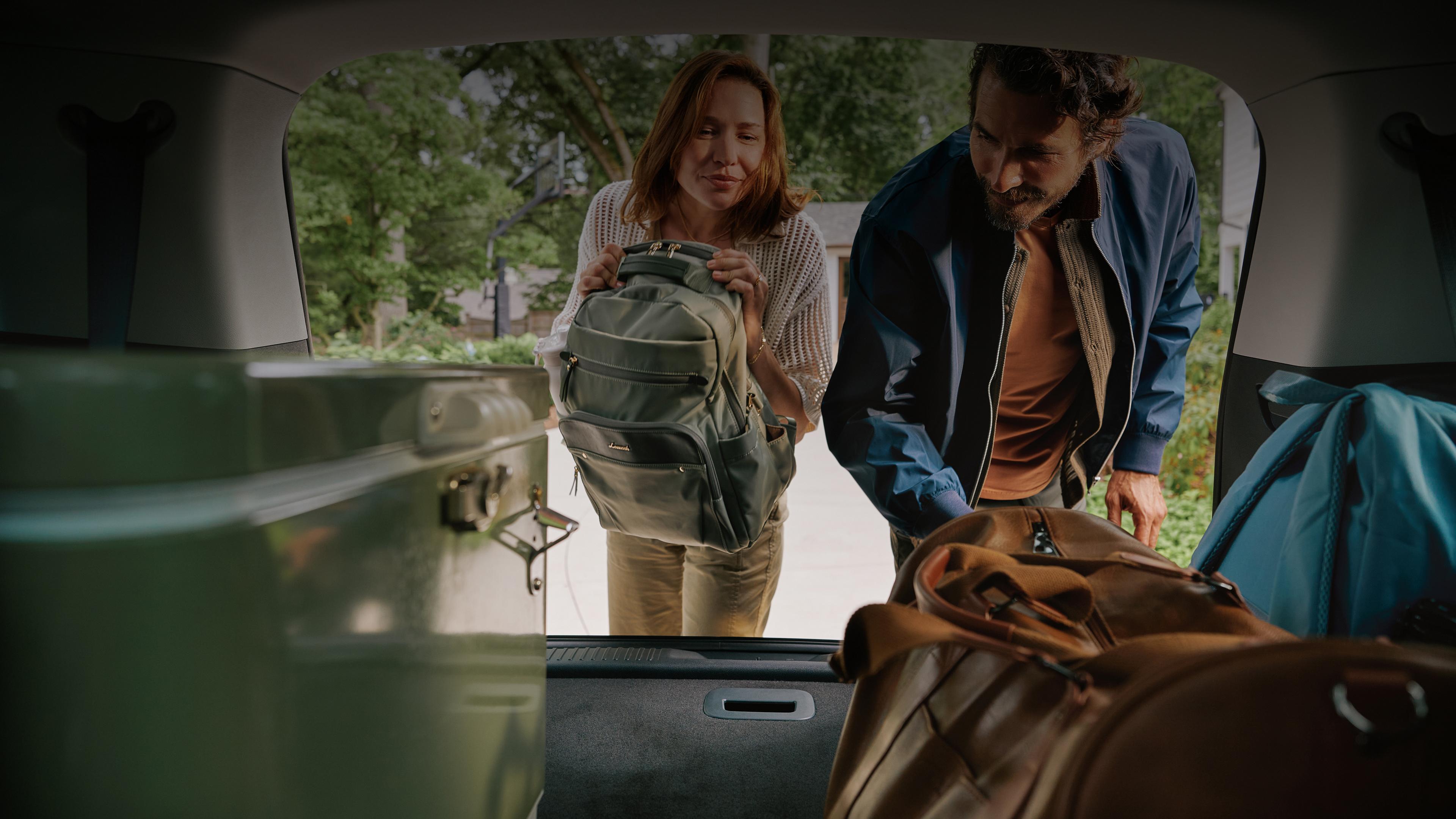 A couple load cargo into the rear of a 2027 Lincoln Aviator®