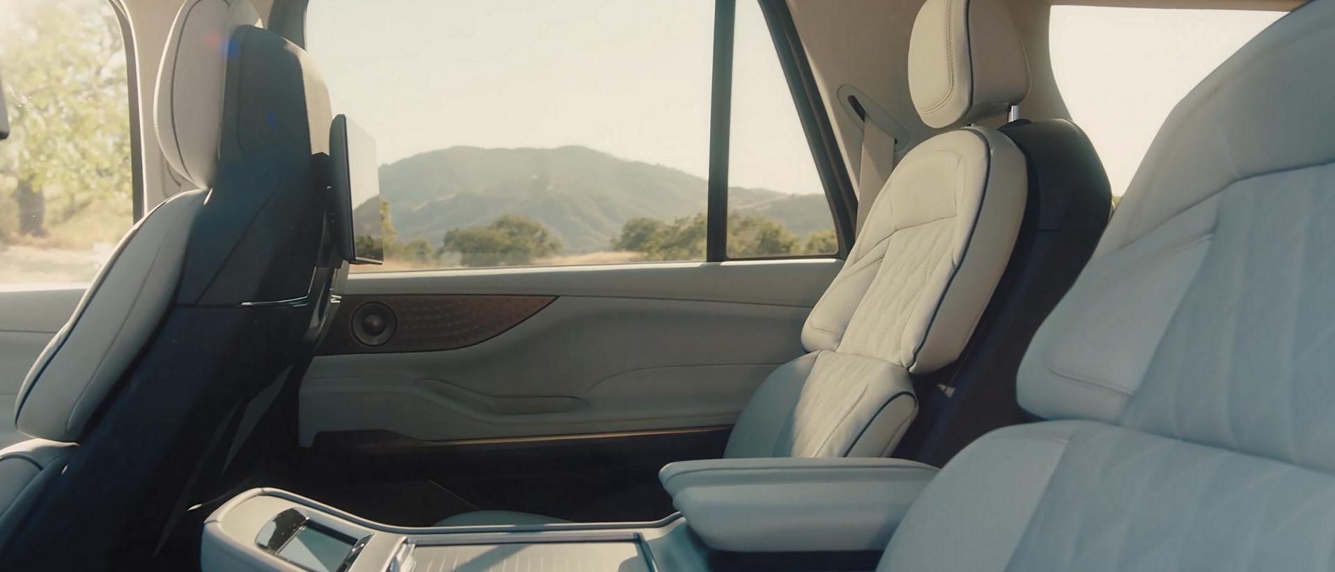 A clip of the interior of a 2026 Lincoln Black Label Navigator® SUV with the Atmospheric theme and then Enlighten theme