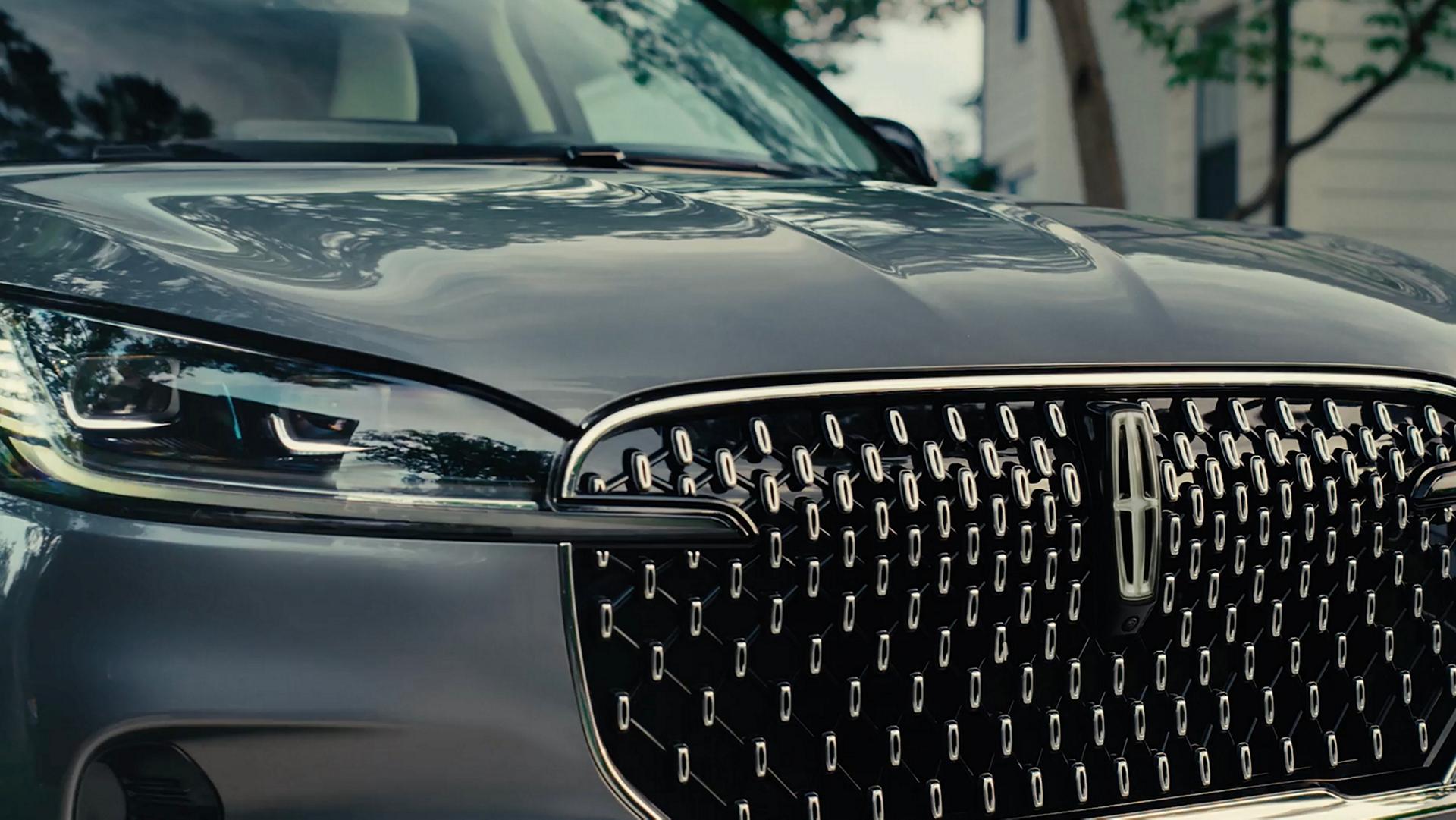 The Lincoln Embrace sequence illuminates on the grille of a 2027 Lincoln Aviator