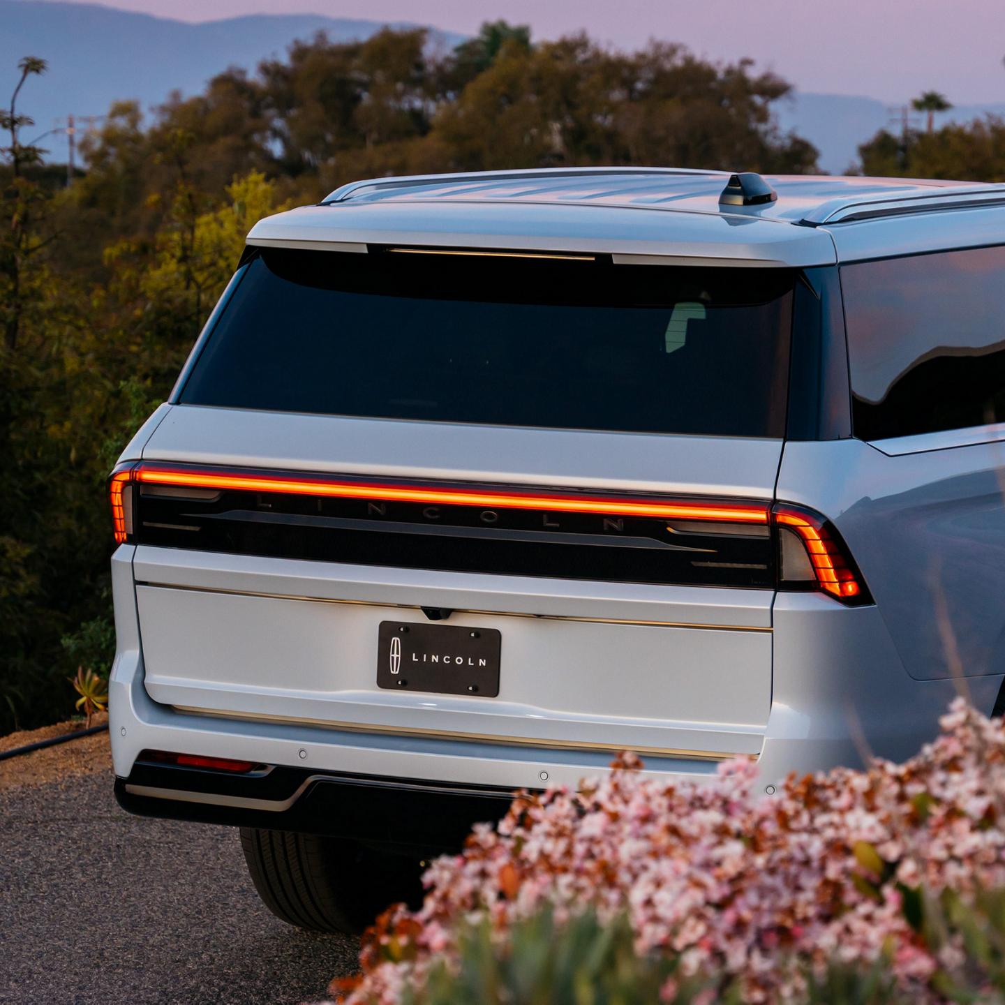 A rear shot of a 2027 Lincoln Navigator® SUV with the taillights illuminated