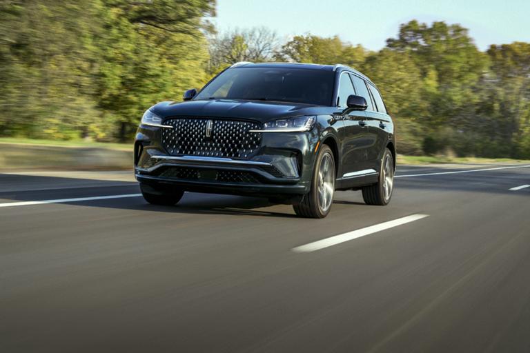 The Lincoln Aviator driving down a road.