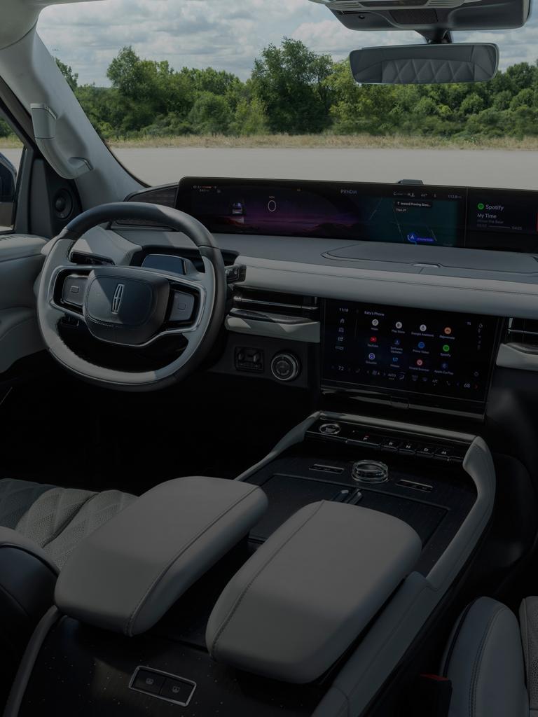 The panoramic display of a 2026 Lincoln Navigator® shown with a variety of apps showing on the centre stack screen