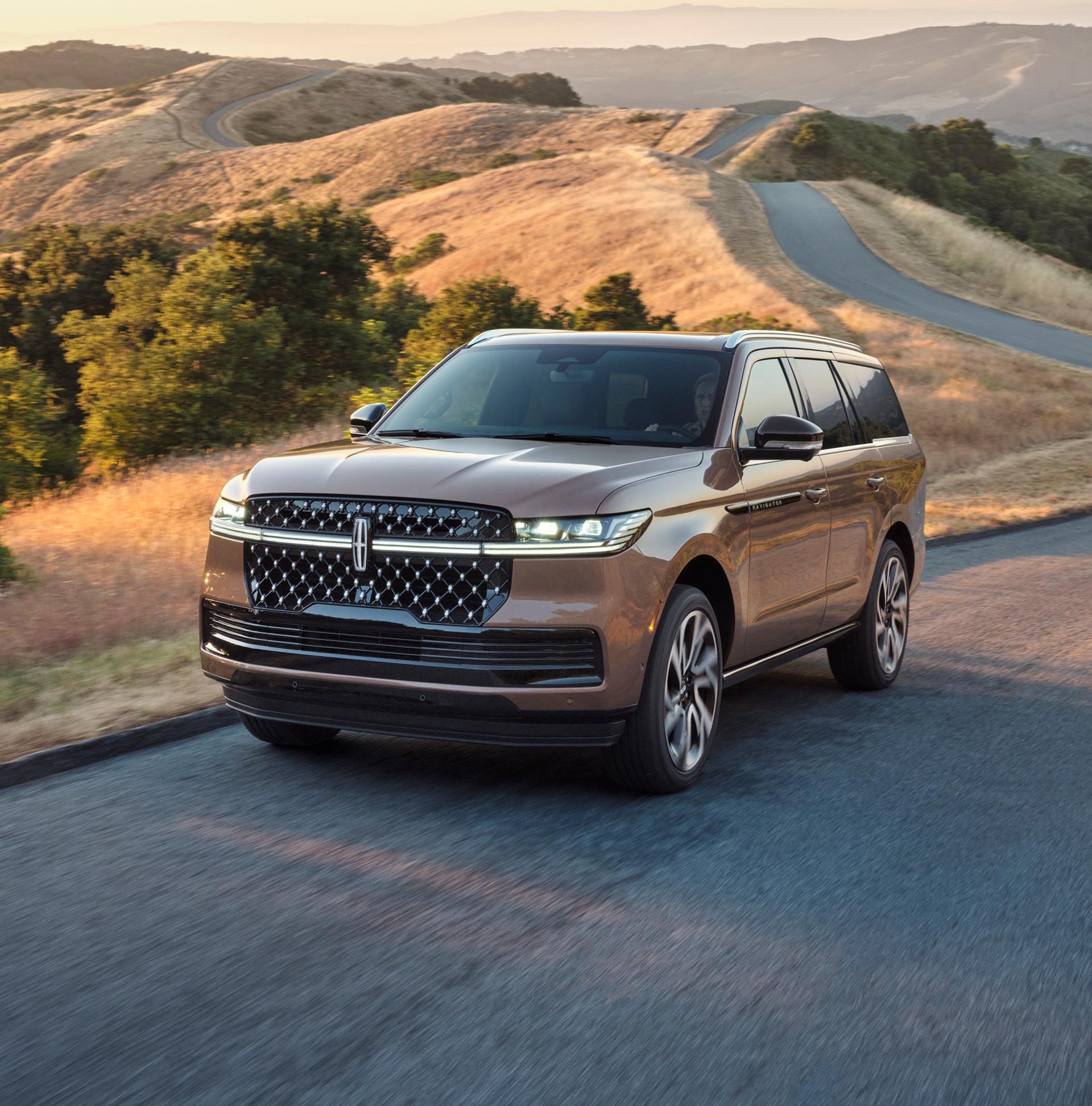 A 2026 Lincoln Black Label Navigator® SUV is being driven on a rural road