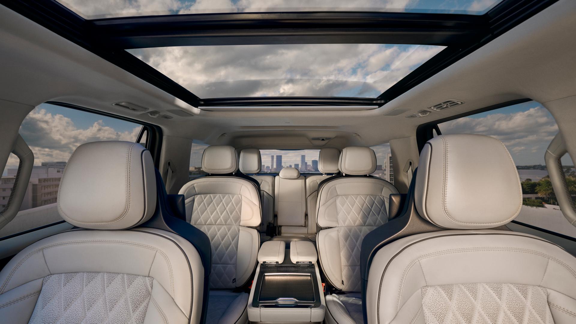 The spacious interior of a 2026 Lincoln Black Label Navigator looking through the cabin, with the Panoramic Vista roof above