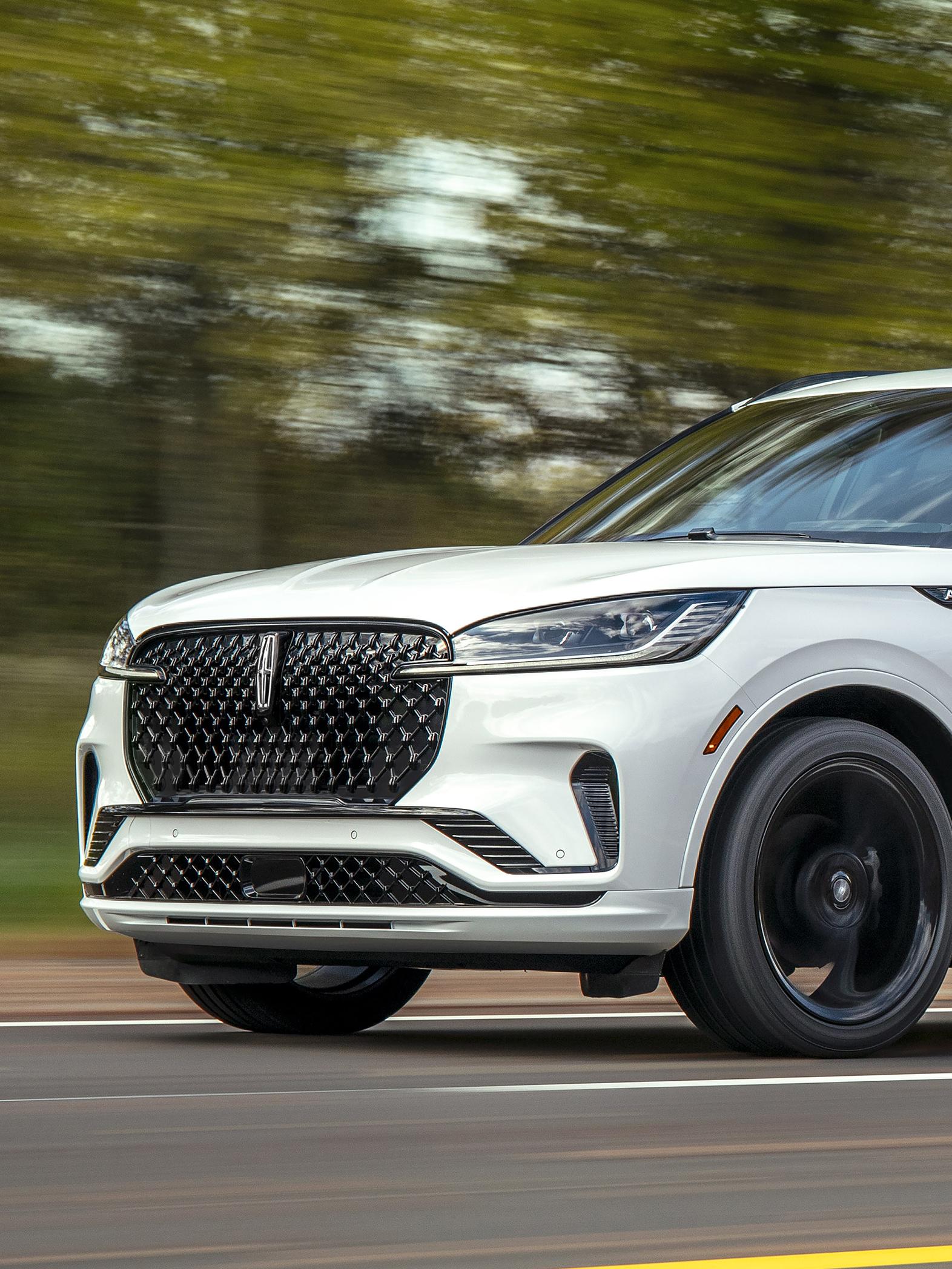 A 2026 Lincoln Aviator® is being driven on a country road