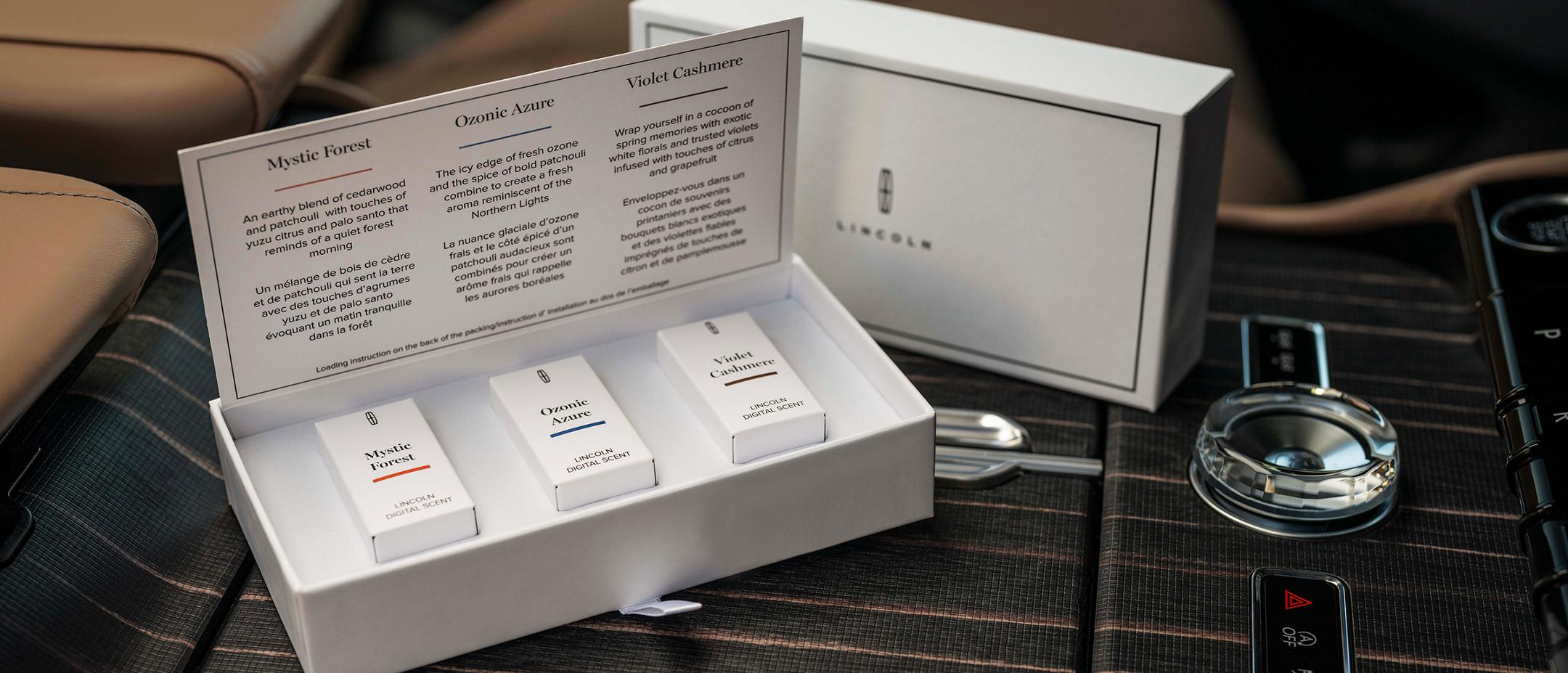 The digital scent cartridges are shown in a box inside a Lincoln vehicle.