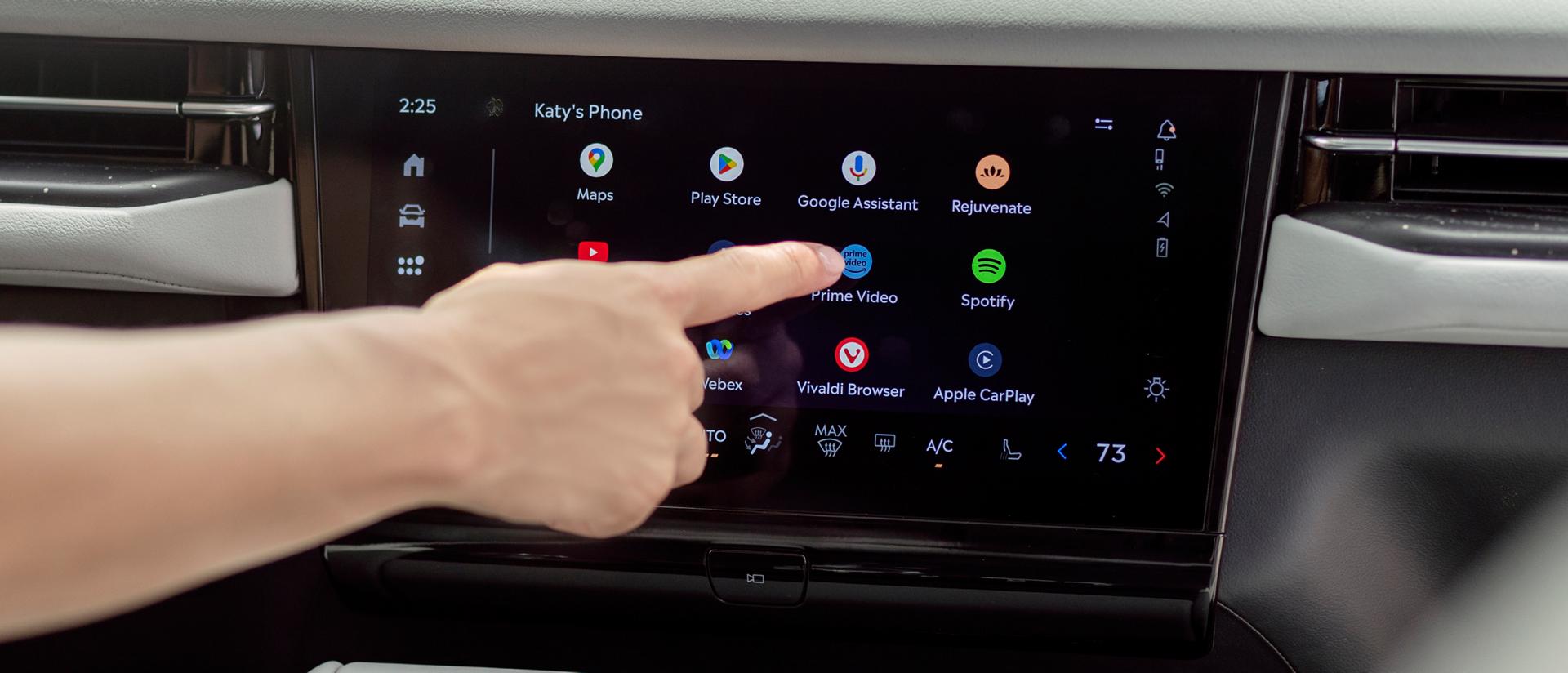A person interacts with the centre display to access apps for streaming, gaming, and working