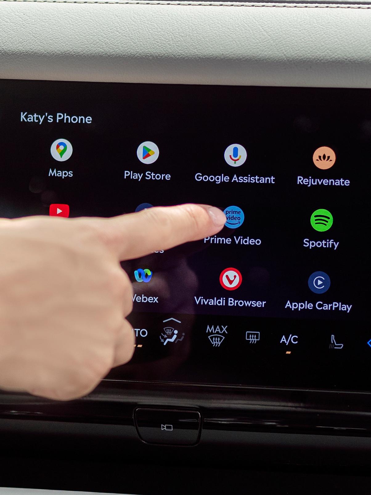 A person interacts with the centre display to access apps for streaming, gaming, and working