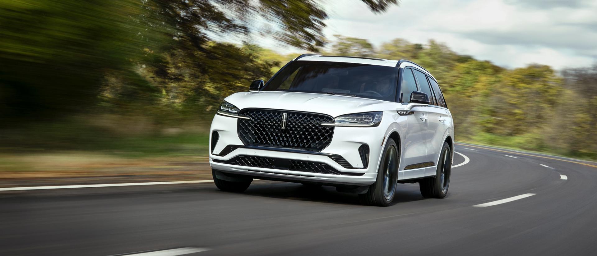 A 2026 Lincoln Aviator® is being driven on a country road