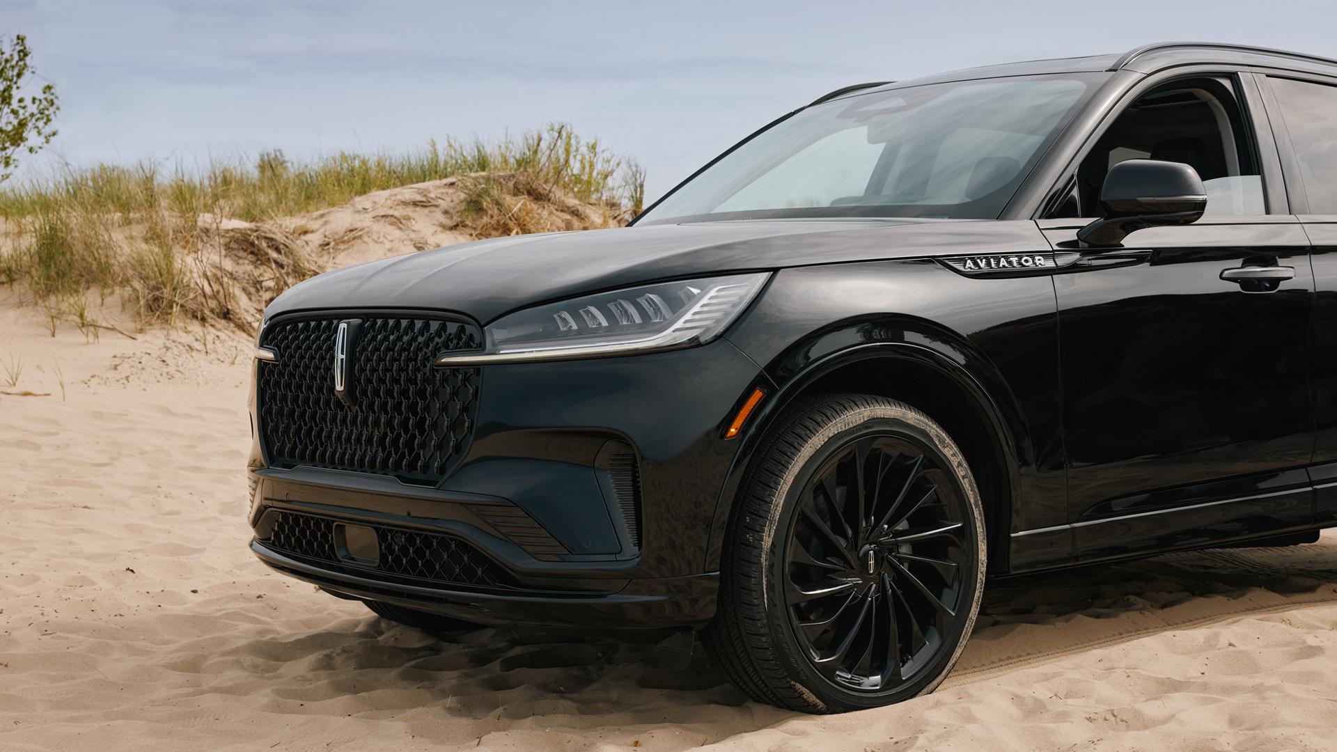 A 2027 Lincoln Aviator® is parked near lakeshore sand dunes