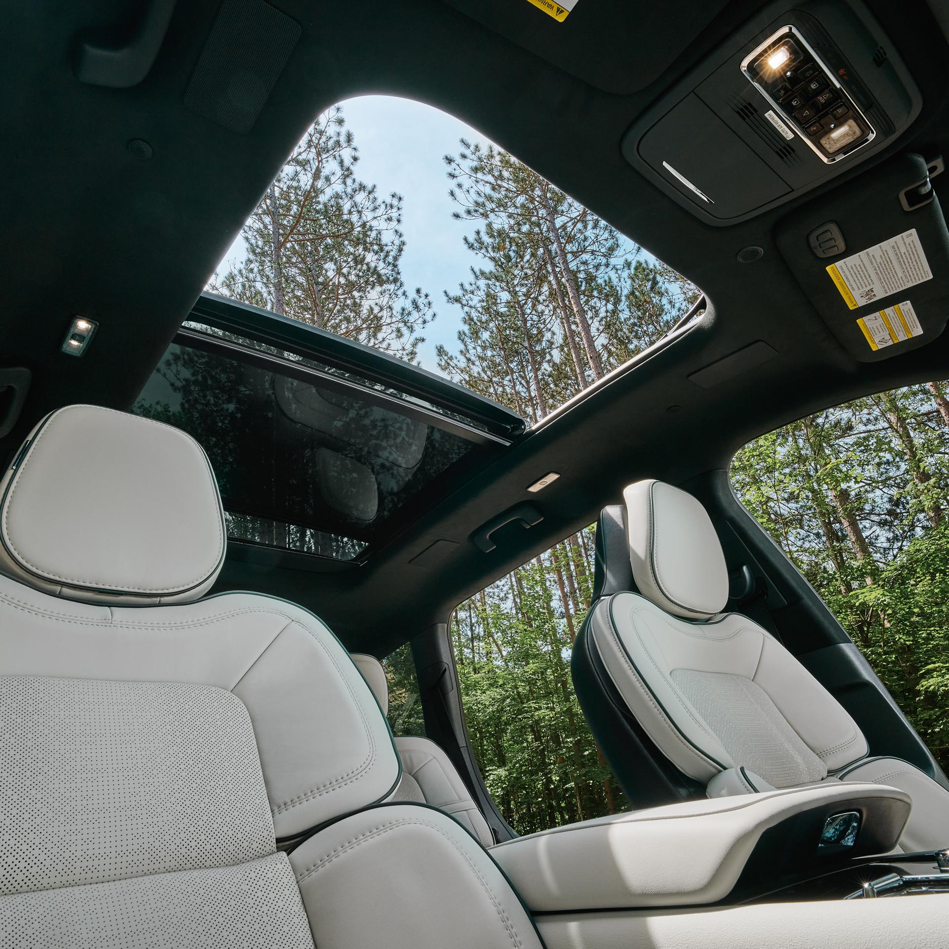 The available panoramic Vista Roof® is shown open from inside a 2027 Lincoln Aviator®