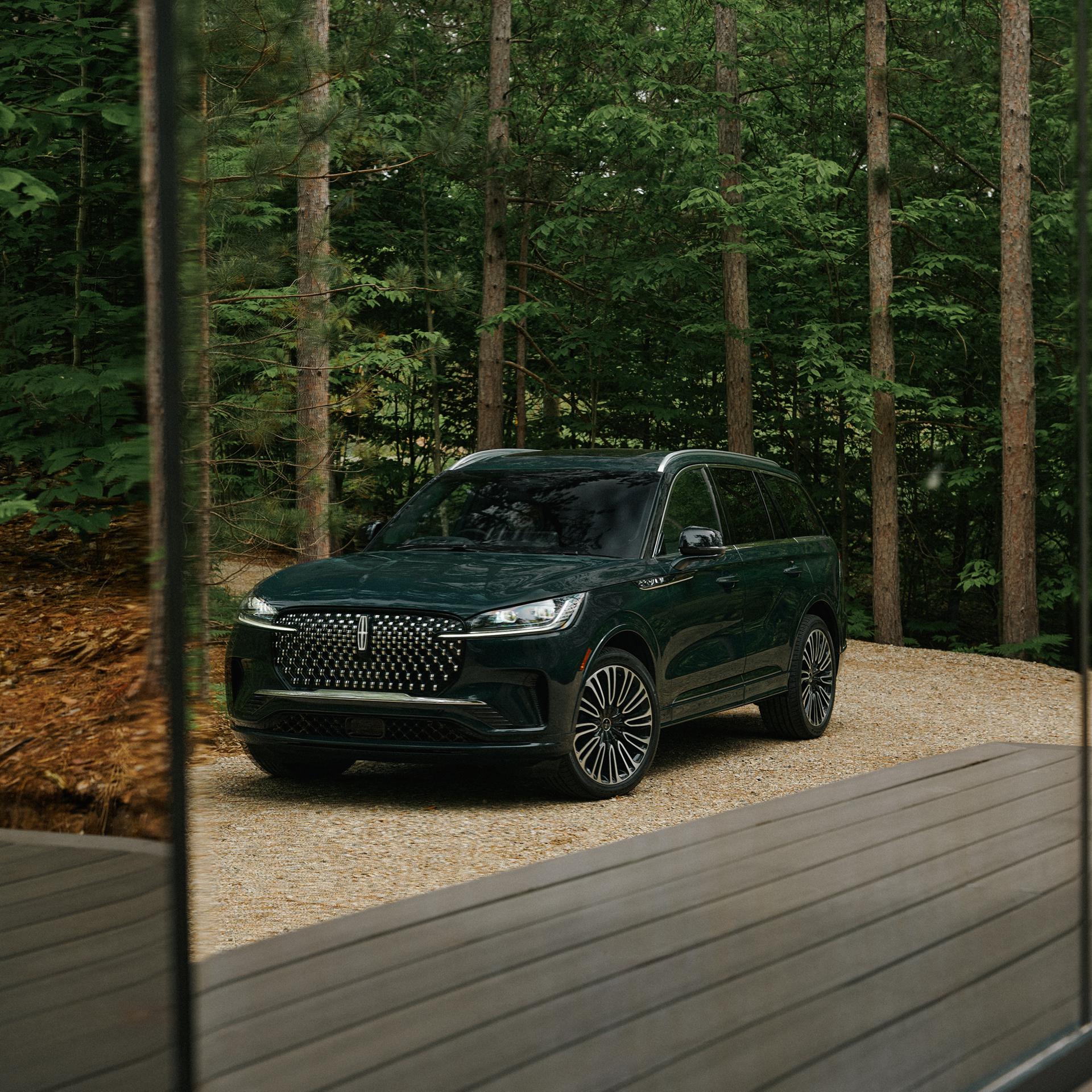 A 2027 Lincoln Aviator® Black Label™ parked next to a high end glamping site