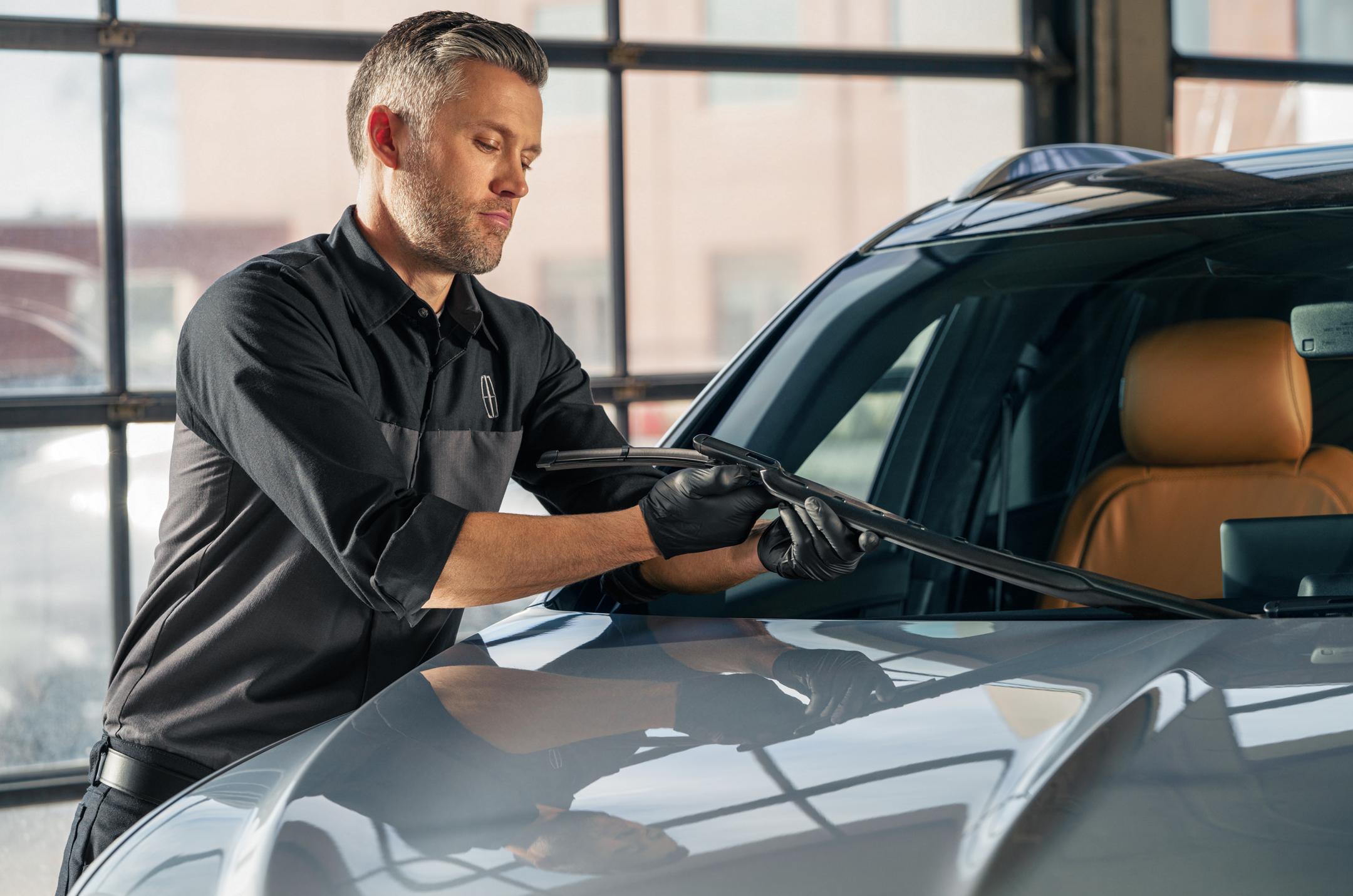 Lincoln technician inspecting wiper blades.