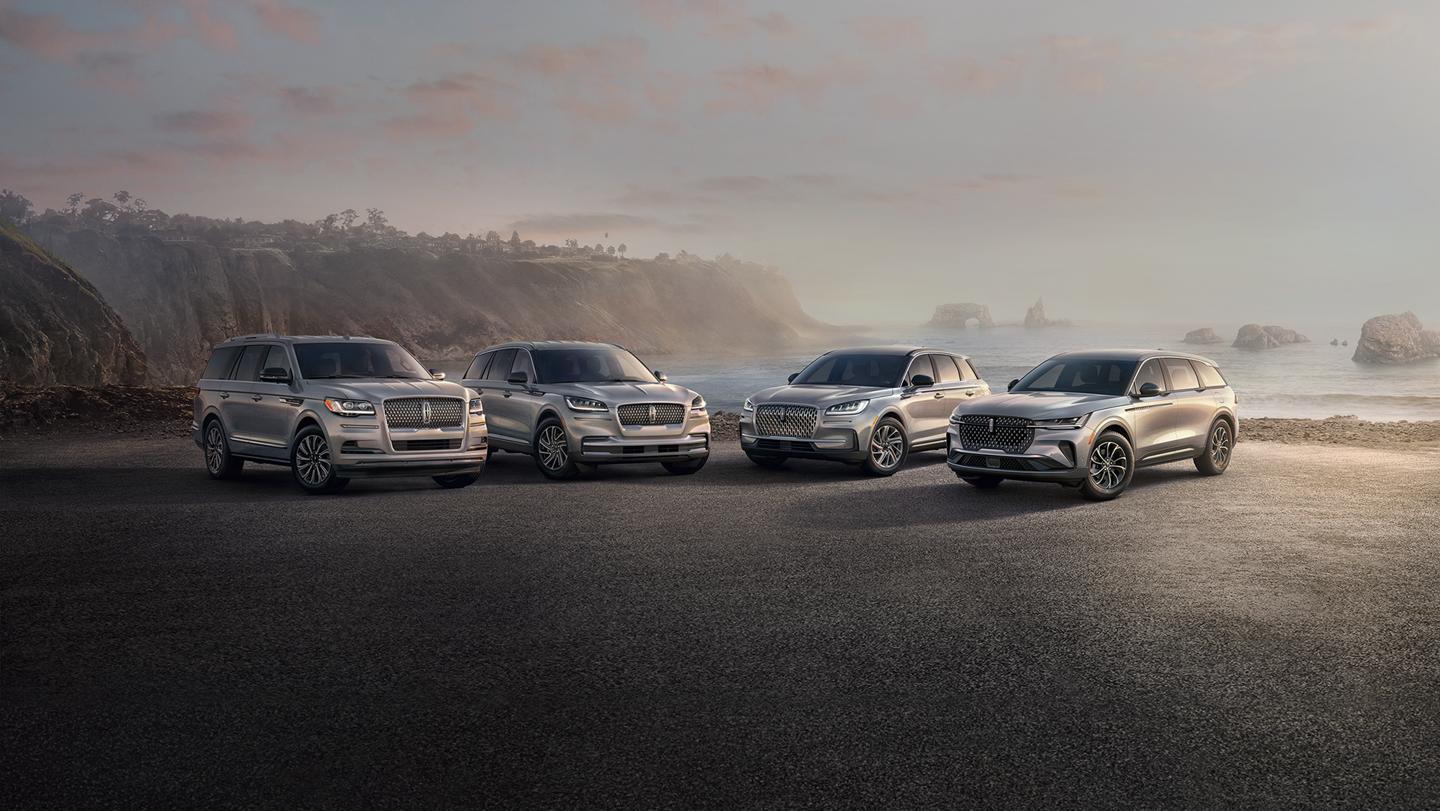 Lincoln Navigator, Aviator, Nautilus, and Corsair lined up in a scenic oceanfront view.