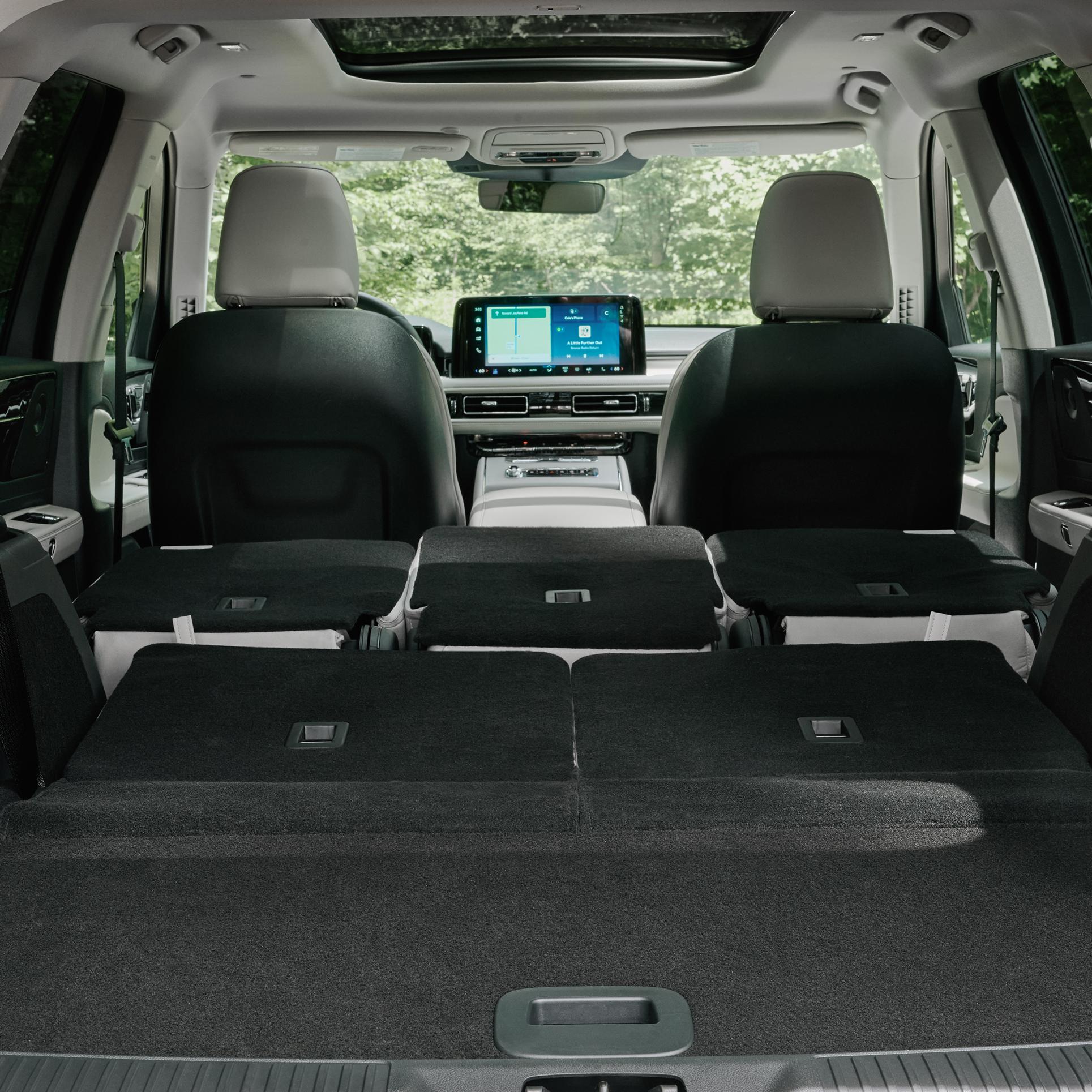The full cabin of a 2027 Lincoln Aviator® as seen from the open rear liftgate looking forward