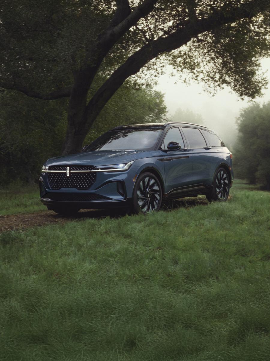 Lincoln Nautilus SUV parked in a scenic, tree-lined setting.