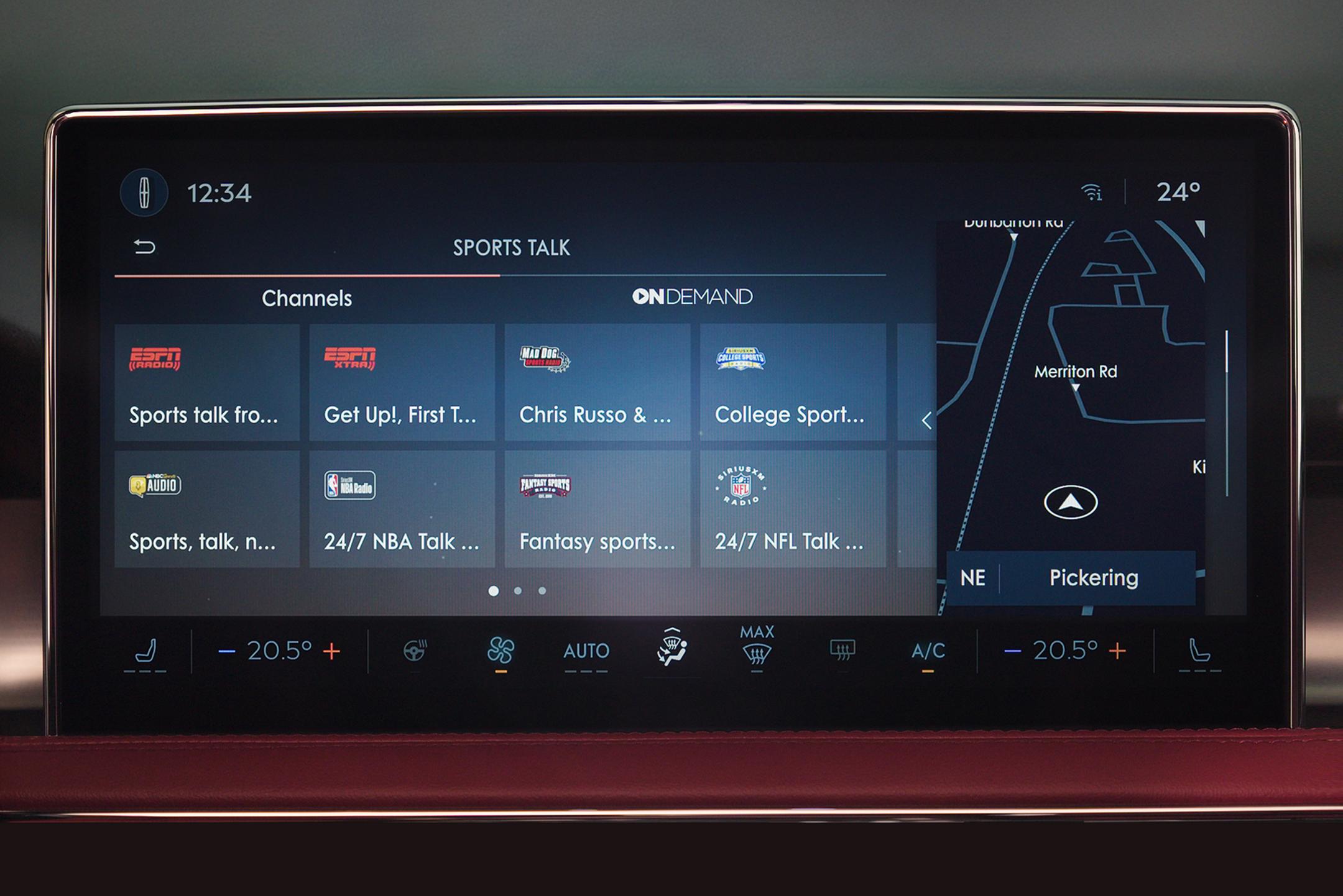A Lincoln in-car infotainment system displaying the "Sports Talk" section with various channels and on-demand content, alongside the navigation map and climate controls.