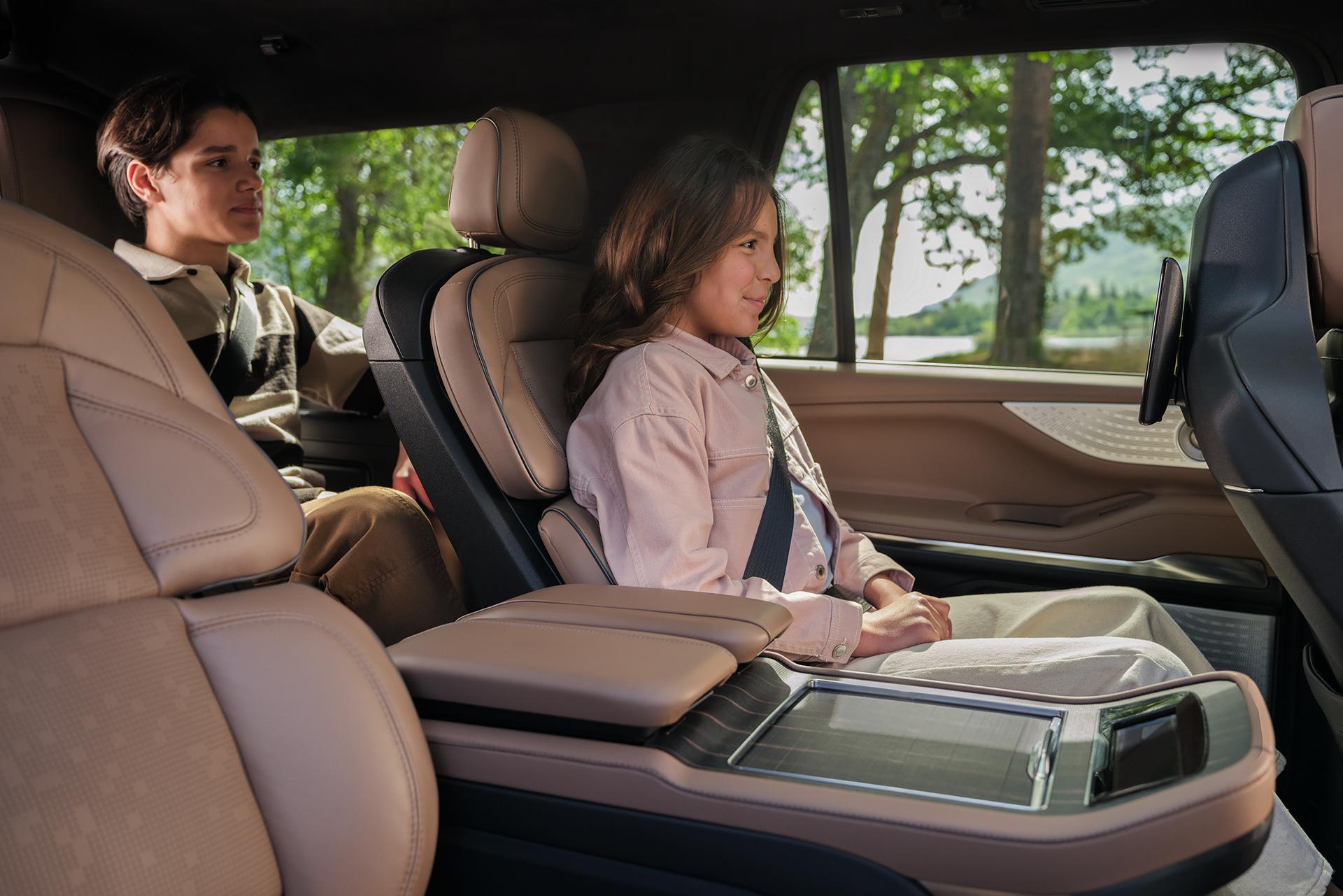Two children sit comfortably in the second and third rows of a 2026 Lincoln Black Label Navigator®