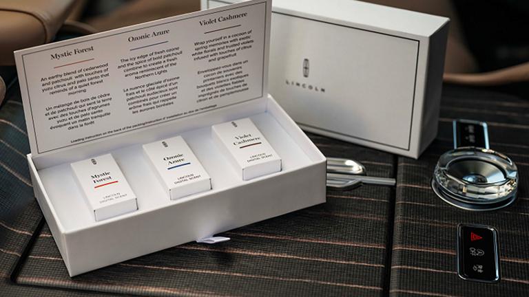 Lincoln Digital Scent cartridges rest on the centre console of a Lincoln SUV