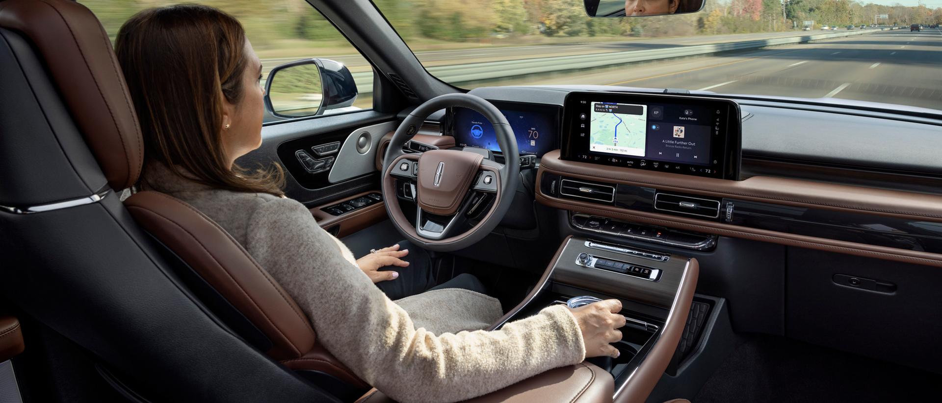 A driver of a 2027 Lincoln Aviator® safely enjoys hands-free highway driving