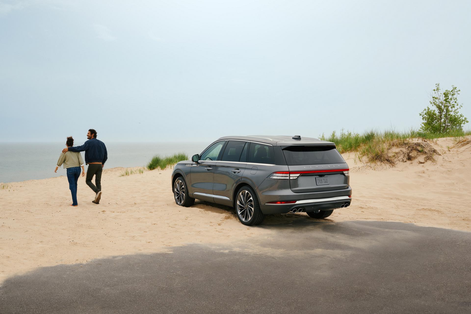 A 2027 Lincoln Aviator® is parked by lake side sand dunes