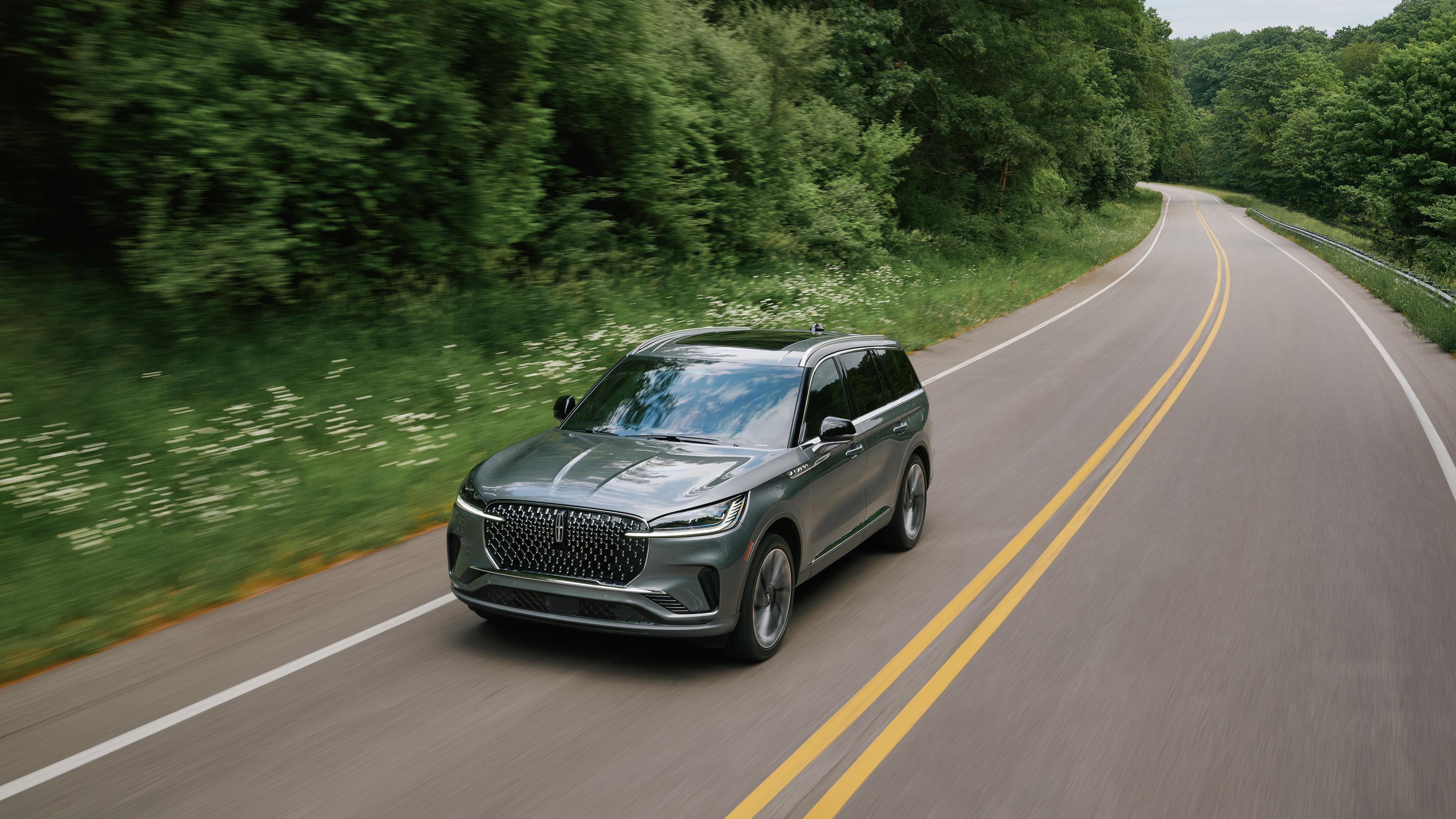 A 2027 Lincoln Aviator® is being driven on a country road