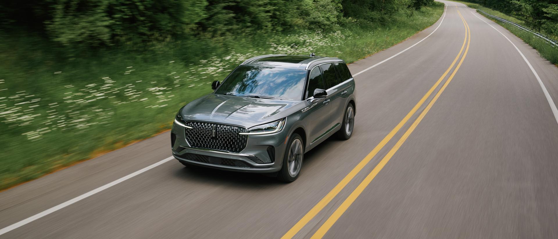 A 2027 Lincoln Aviator® is being driven on a country road
