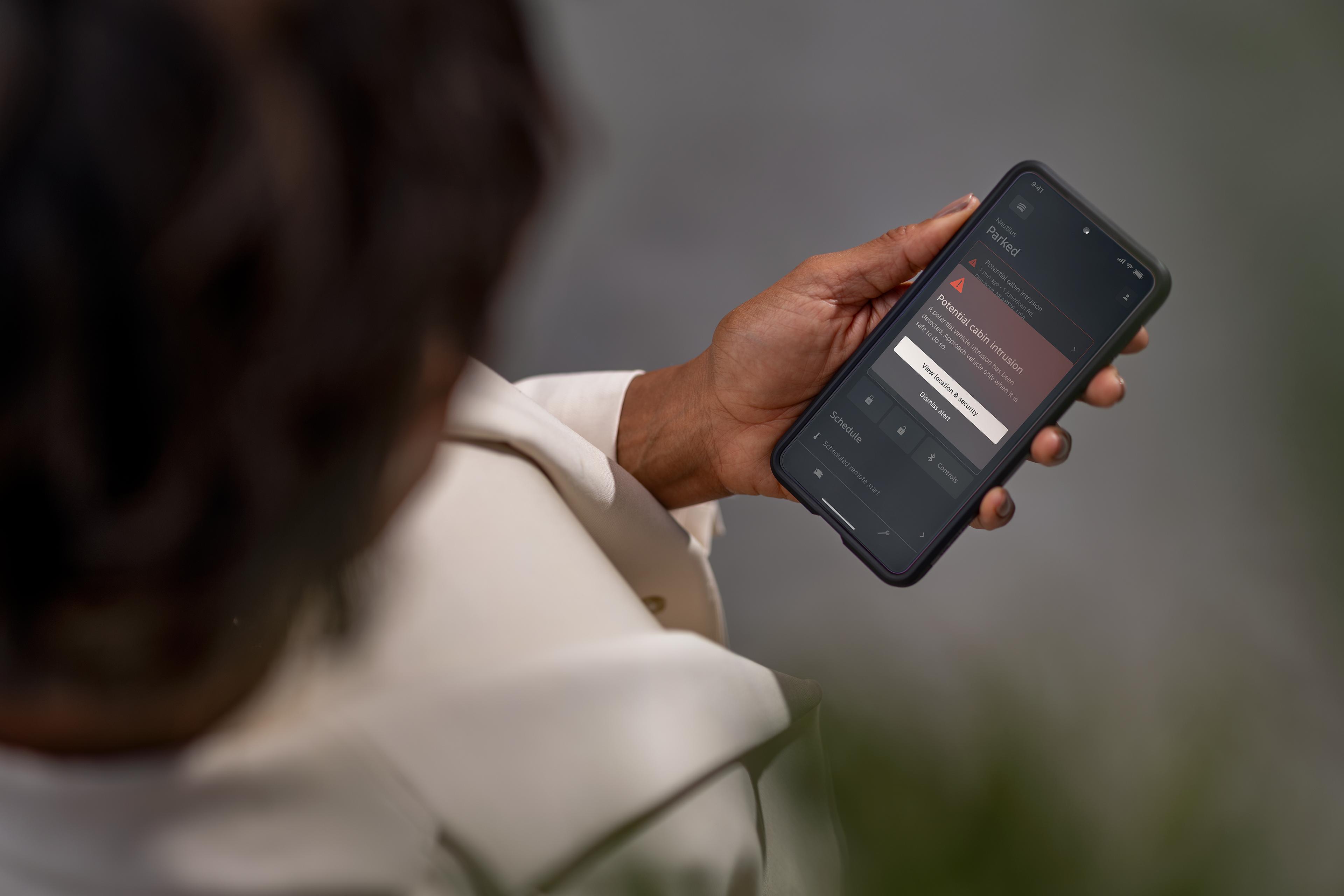 A person accesses security features on smartphone app