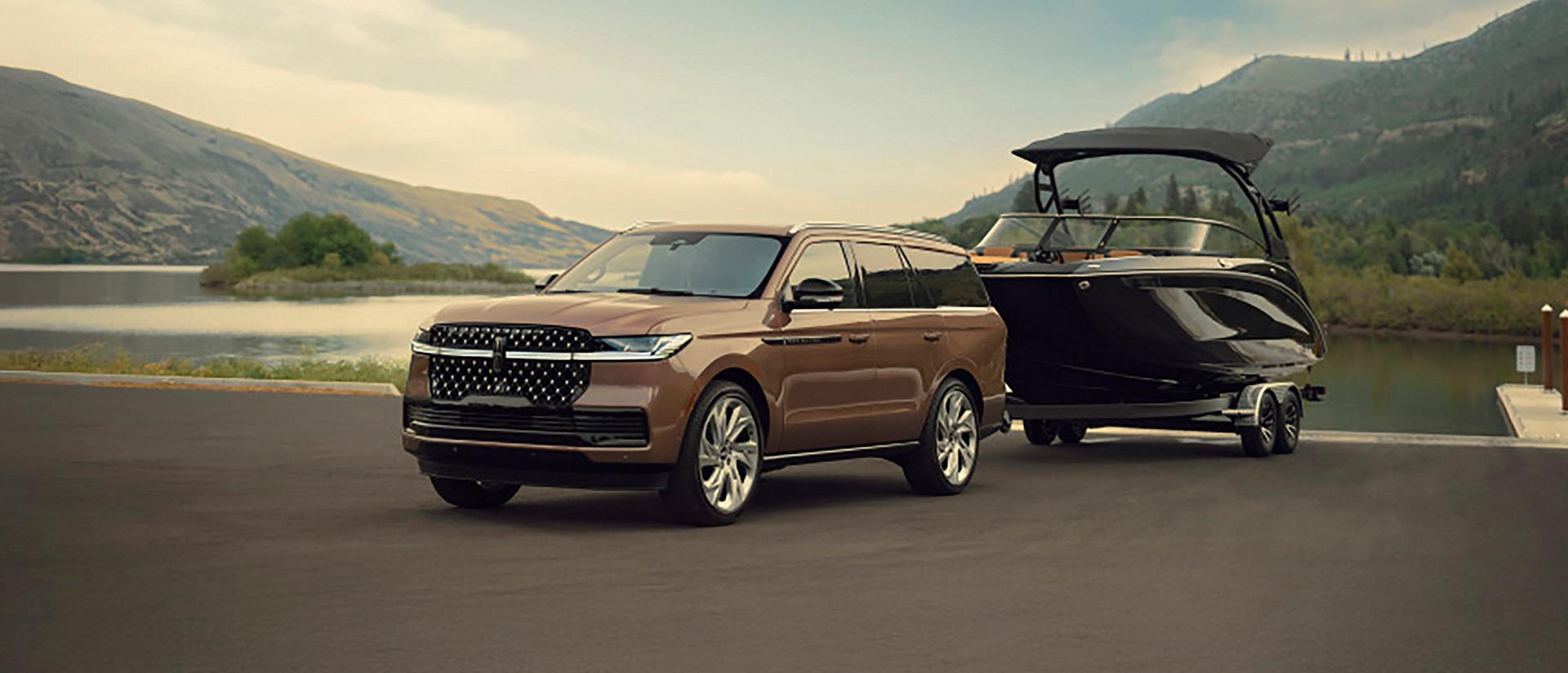 A 2026 Lincoln Navigator® SUV tows a large boat