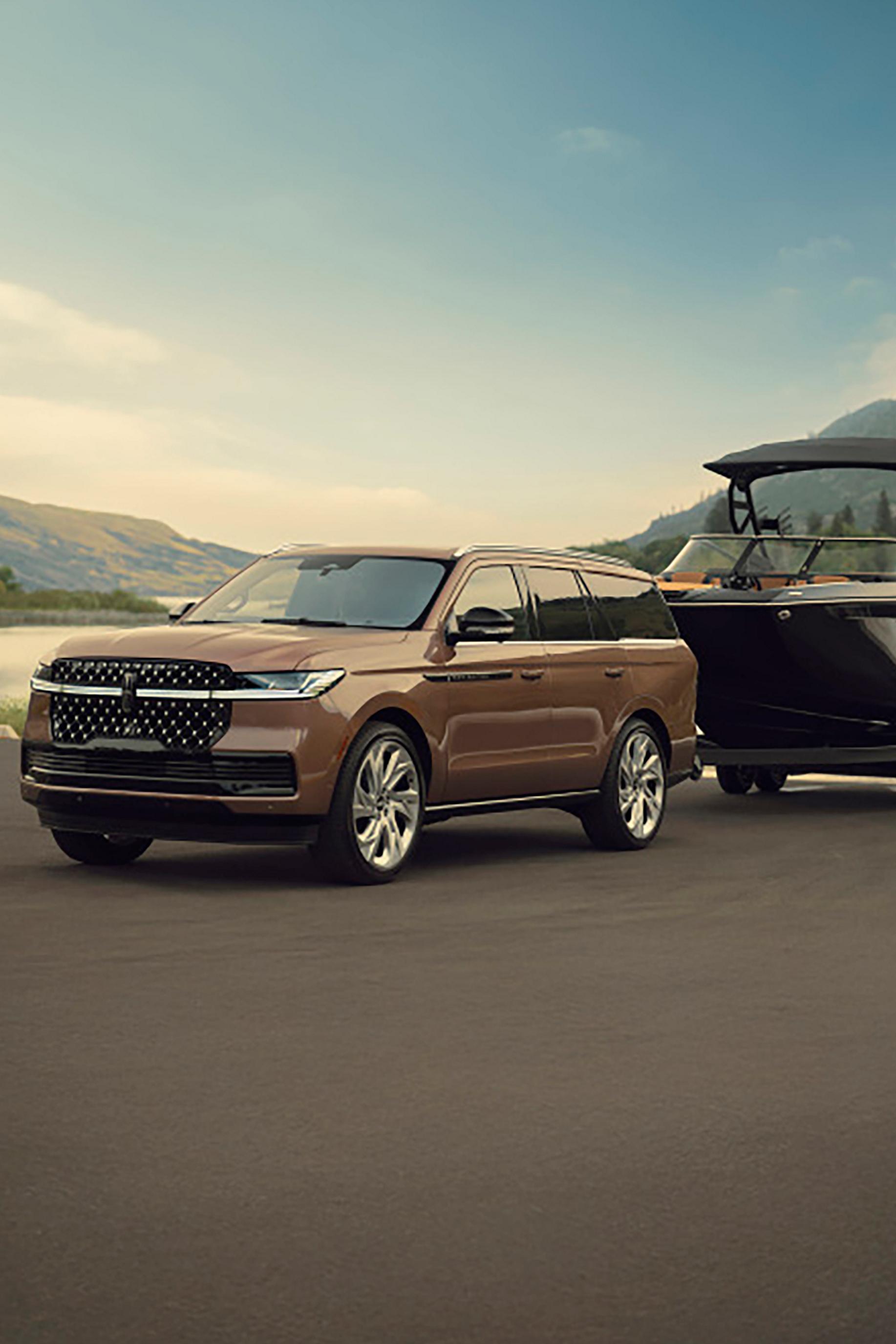 A 2026 Lincoln Navigator® SUV tows a large boat