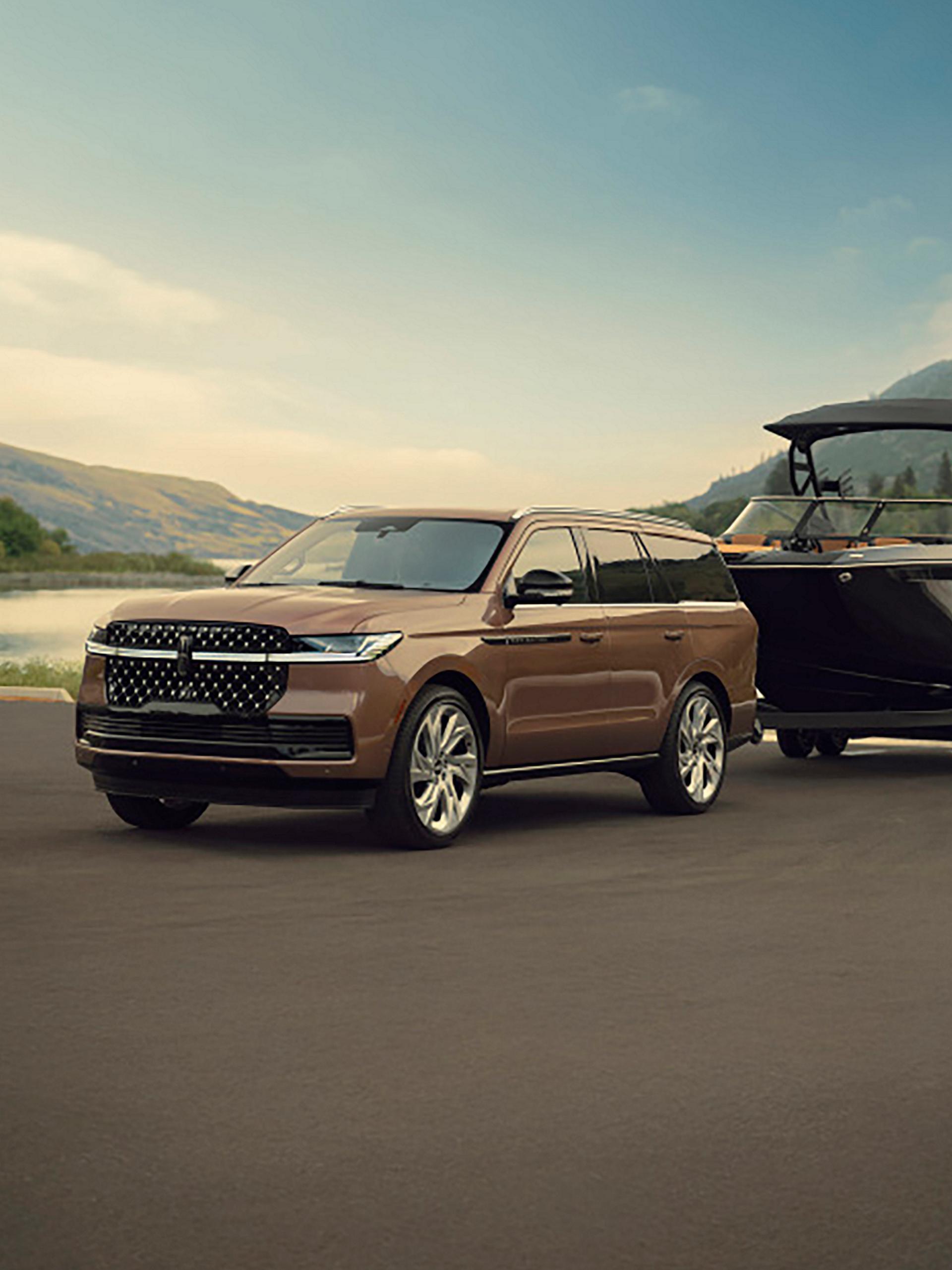 A 2026 Lincoln Navigator® SUV tows a large boat