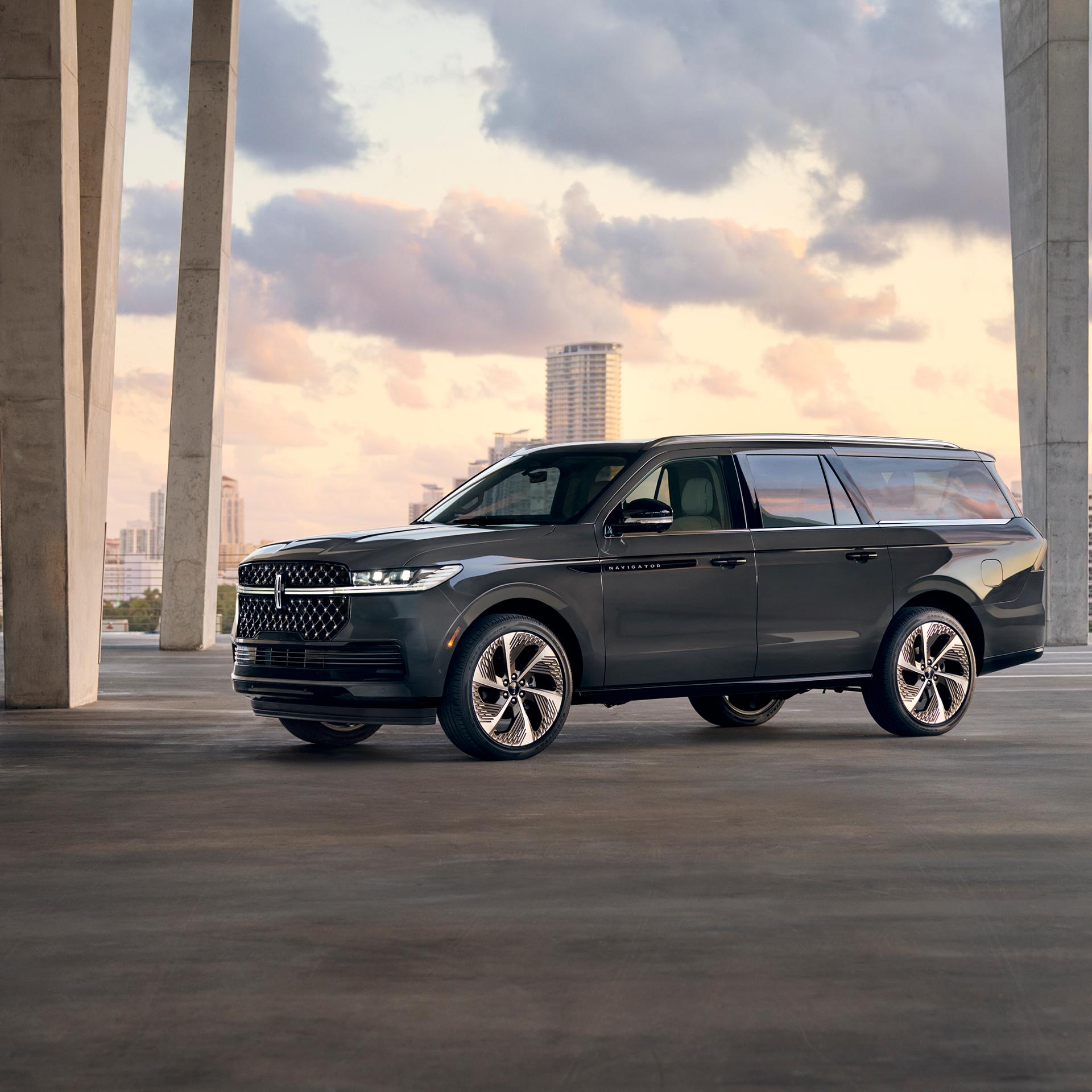 A 2026 Lincoln Navigator® SUV with the long wheelbase is parked in front of a cityscape