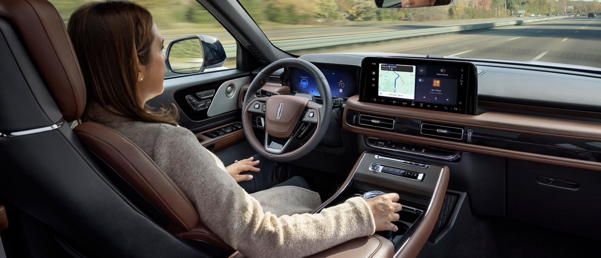 A woman operates the 2026 Lincoln Aviator® hands-free with her eyes on the road using Lincoln BlueCruise