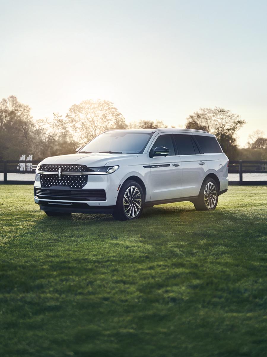 Lincoln Navigator SUV parked in front of a modern house.