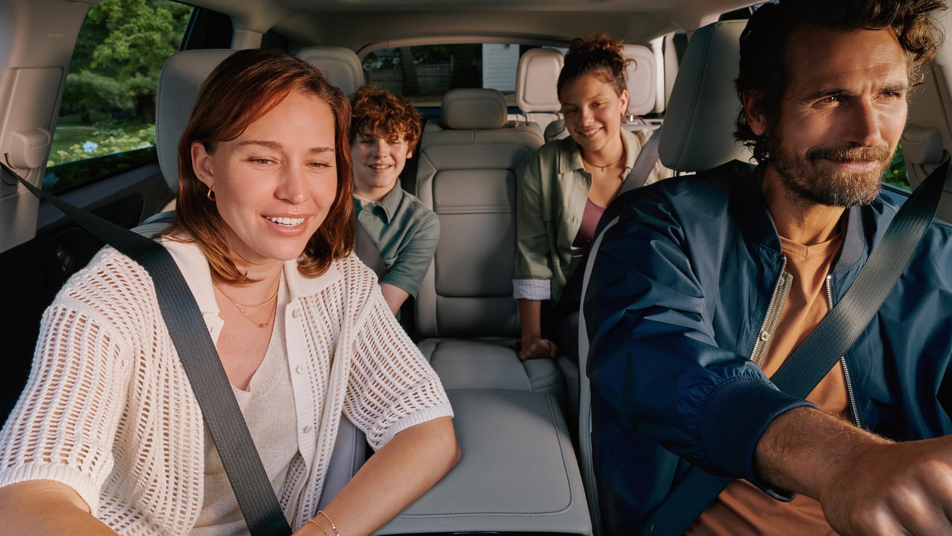 A family is seated comfortably in the front and middle rows of 2027 Lincoln Aviator