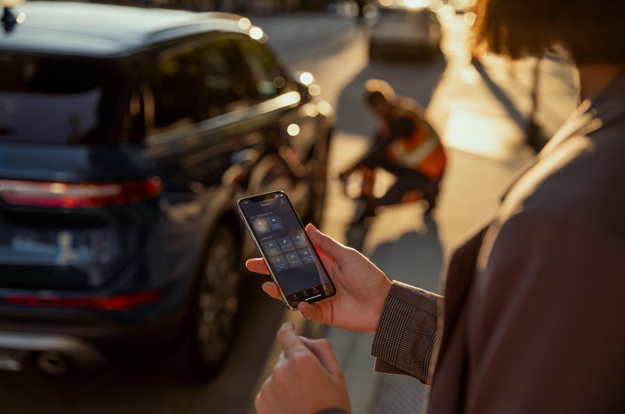 Person on the street using a smartphone.