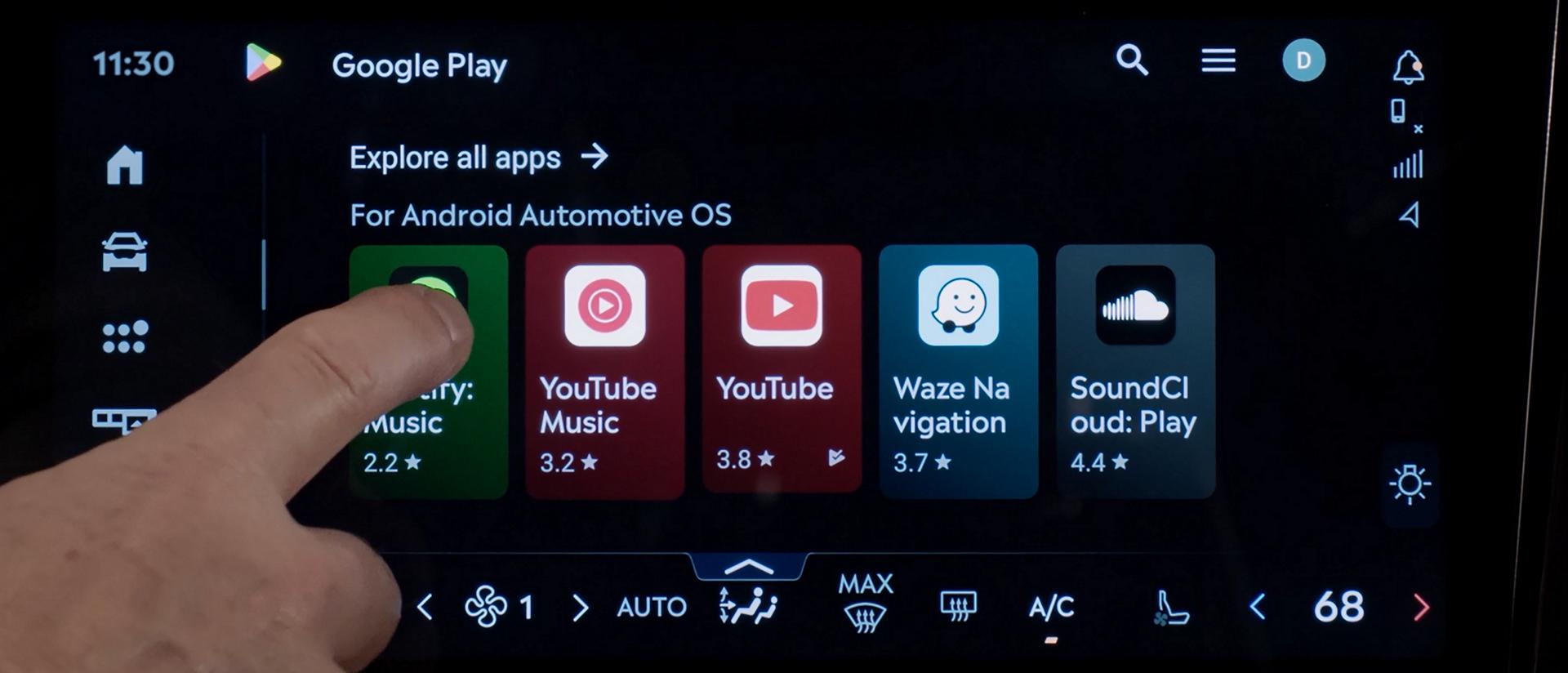 A finger presses a button on the centre touch screen inside a 2026 Lincoln Navigator® SUV