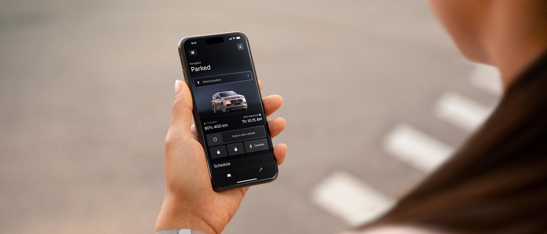 A person holding a mobile phone showcasing the Lincoln app