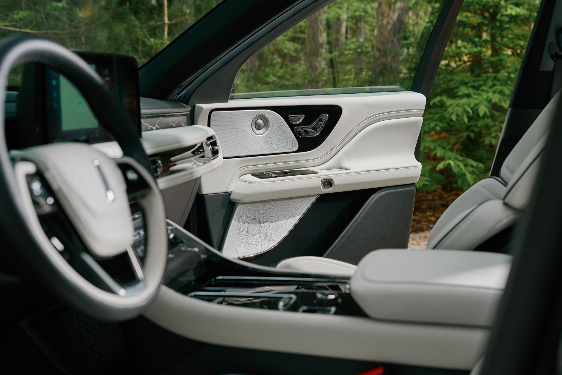 An audio system speaker is located in the front passenger door of a 2027 Lincoln Aviator®