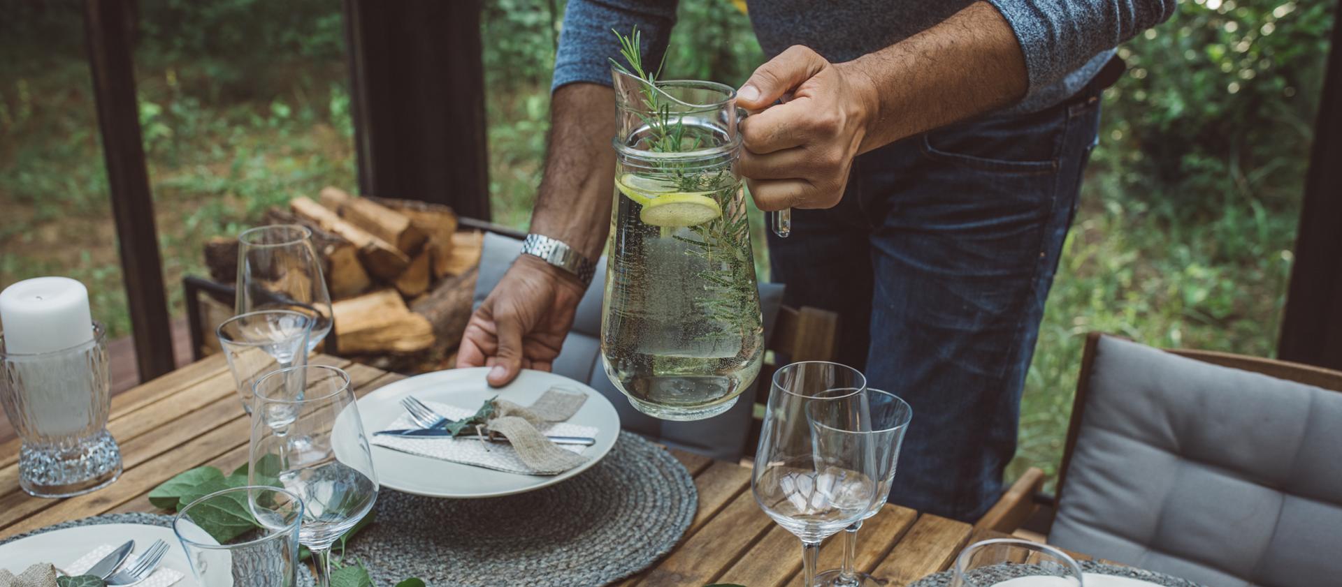 A person sets a dining table to reflect the spirit of the 2027 Lincoln Black Label™ Invitation theme