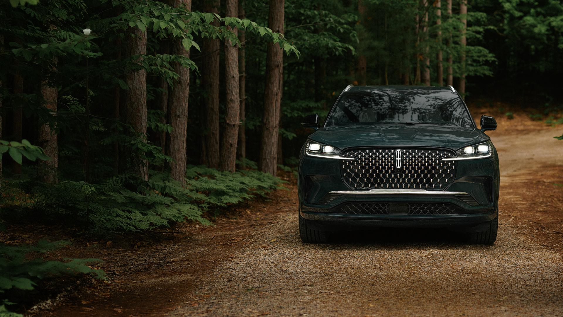 A 2027 Lincoln Aviator® is being driven on a remote forest roadway